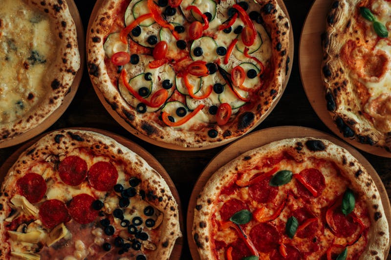 Fresh pizza being crafted at Mod Pizza