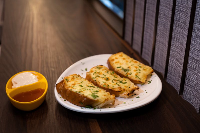 Cheesy garlic bread with herbs and dipping sauce